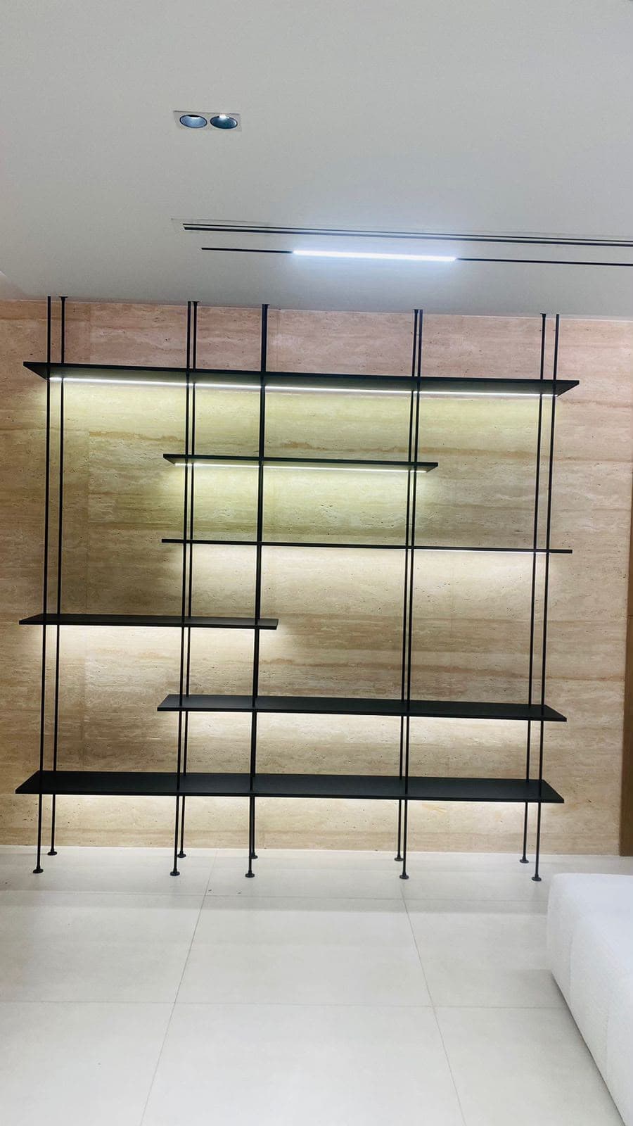Custom-fabricated floating aluminium shelving unit
