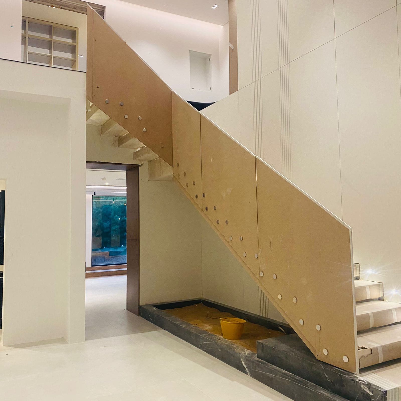 In-house team fabricating a steel and aluminium staircase frame on site