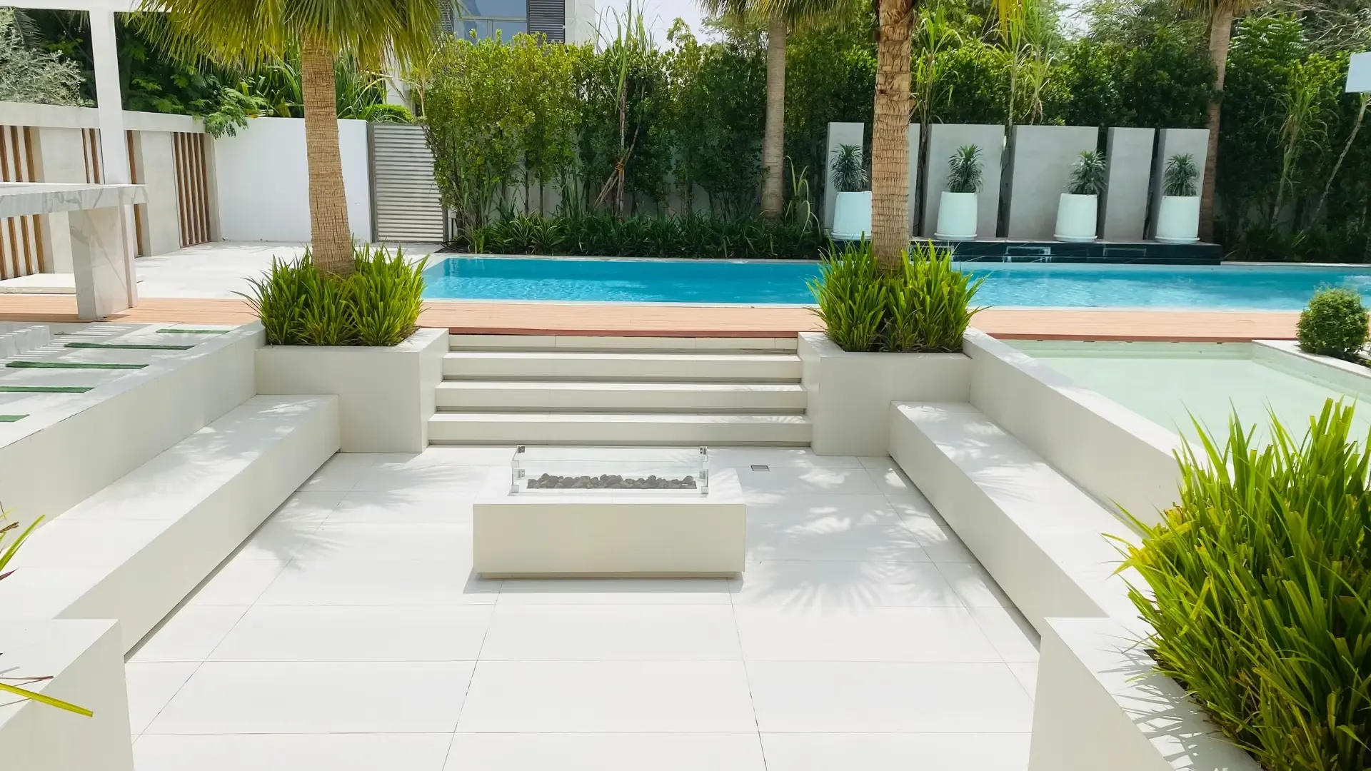 Outdoor seating beside a pool at a villa in Dubai